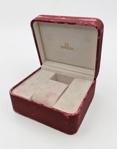 Omega red leather Watch box Circa 2000s gold colour medallion