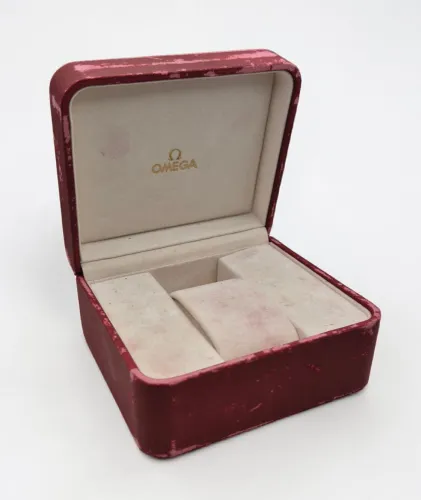 Omega red leather Watch box Circa 2000s gold colour medallion